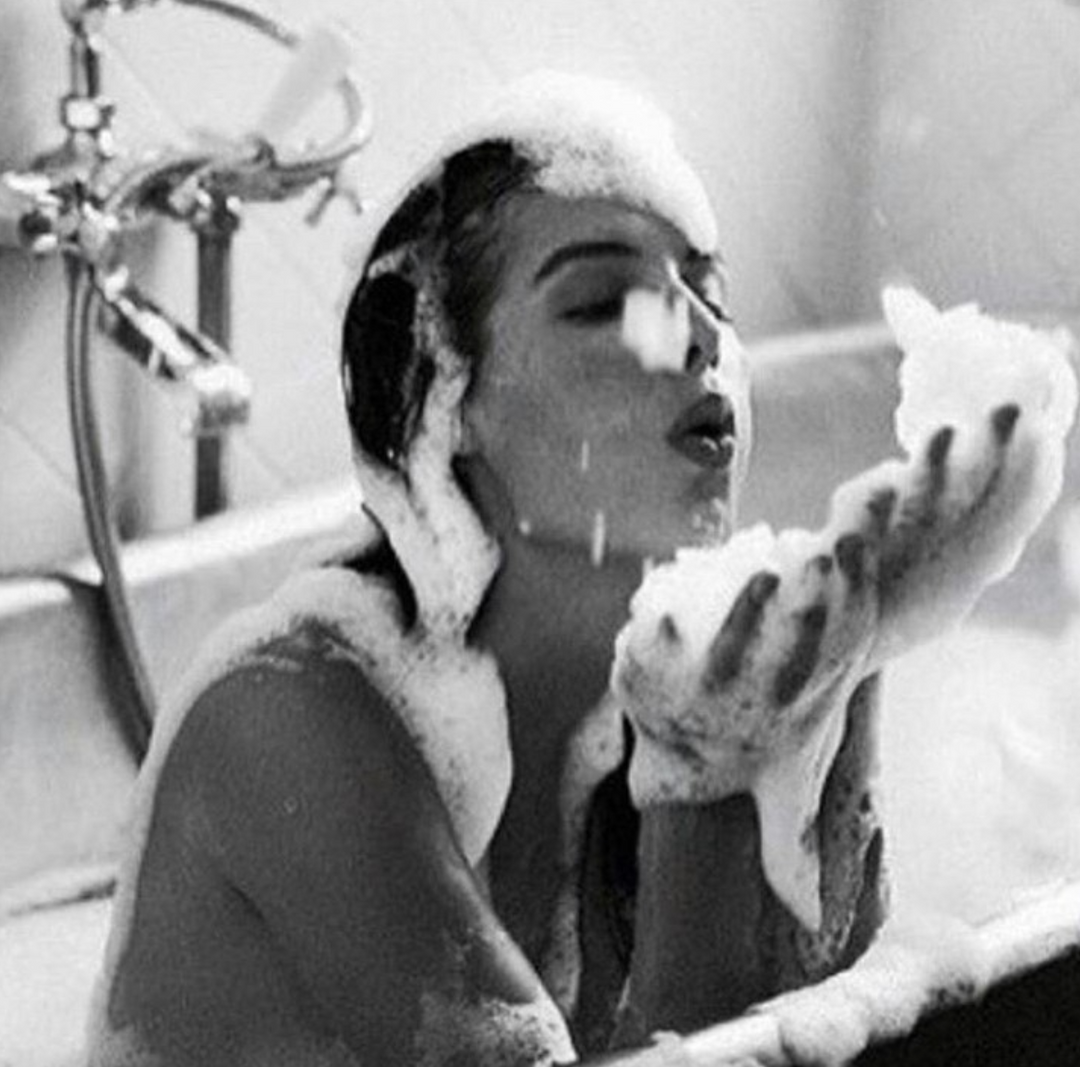 woman in a bathtub covered in bubbles, self care
