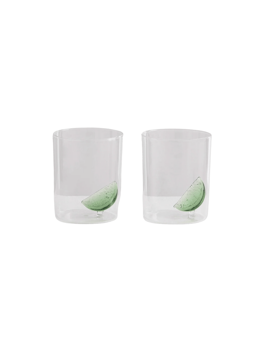 Two clear gin and tonic gobelets with glass lime wedges from Maison Balzac on a transparent background | Twentyseven Toronto