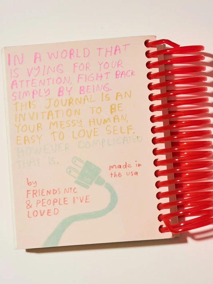 The back cover of the Unplug Journal from People I've Loved shows a colorful handwritten message about fighting back against distractions alongside an illustration of an electrical plug | Twentyseven Toronto
