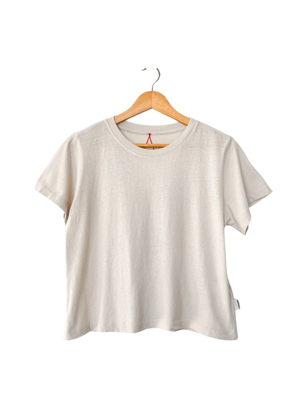 A studio product shot of the Le Bon Shoppe Airy Darling Tee in Rice displayed on a wooden hanger | Twentyseven