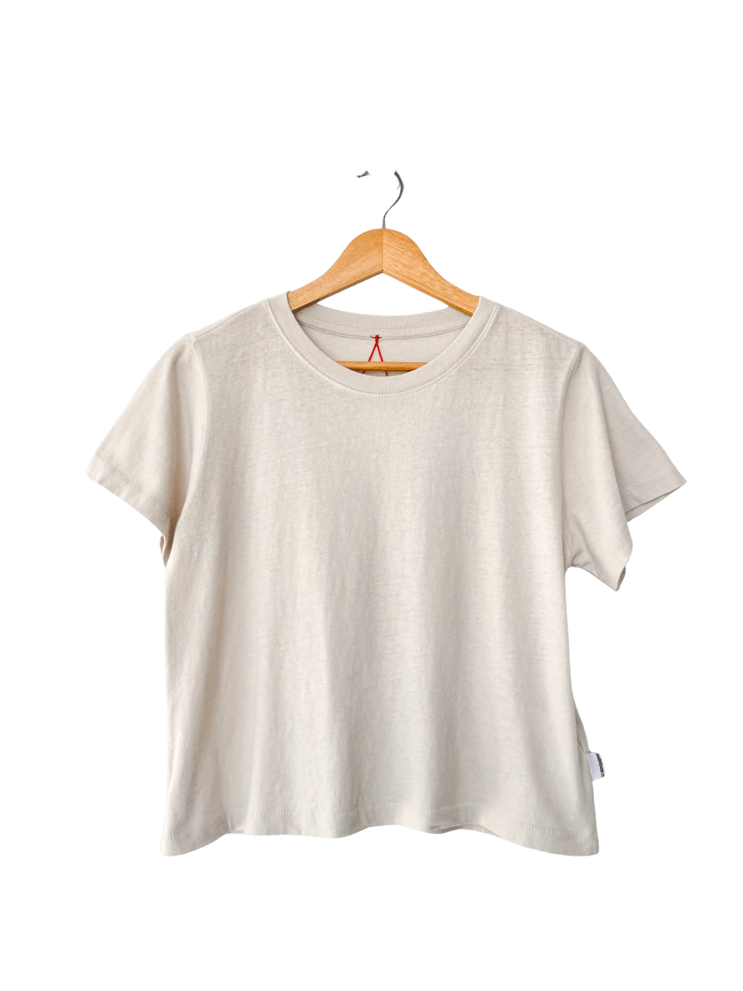 A studio product shot of the Le Bon Shoppe Airy Darling Tee in Rice displayed on a wooden hanger | Twentyseven