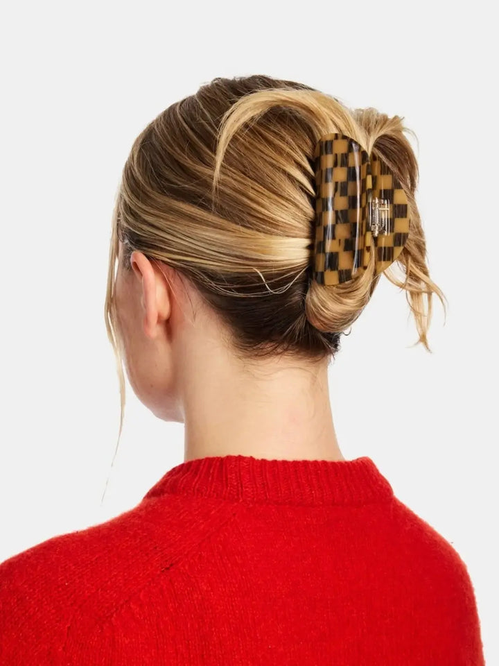 Rear view of a woman wearing a red sweater with blonde hair styled in an updo using the Chunks Checker Claw in Mocha | Twentyseven