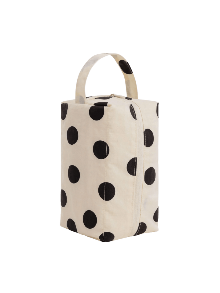 A studio product shot of the BAGGU Dopp Kit in Cream and Black Polka Dot standing upright | Twentyseven