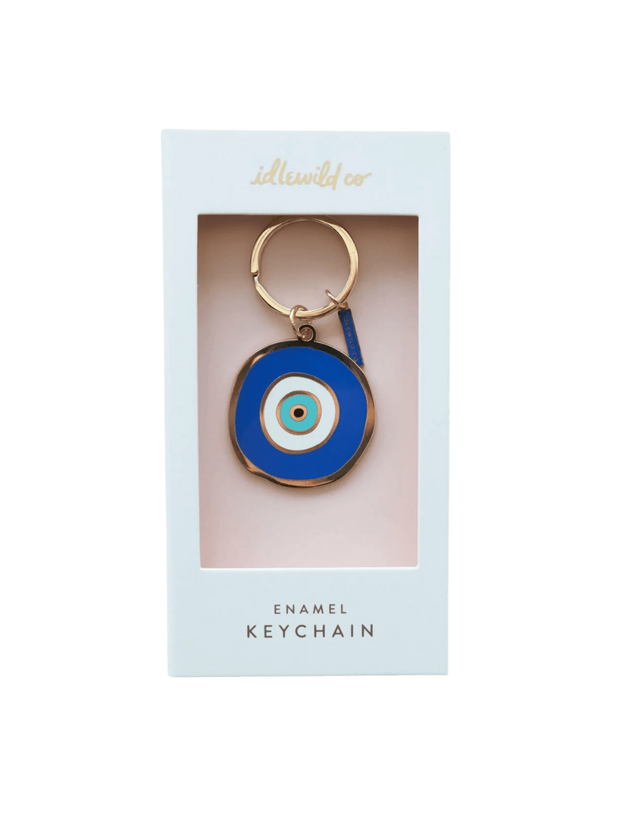A front-facing studio shot of the Idlewild Co. Evil Eye Enamel Keychain in its original white display packaging | Twentyseven