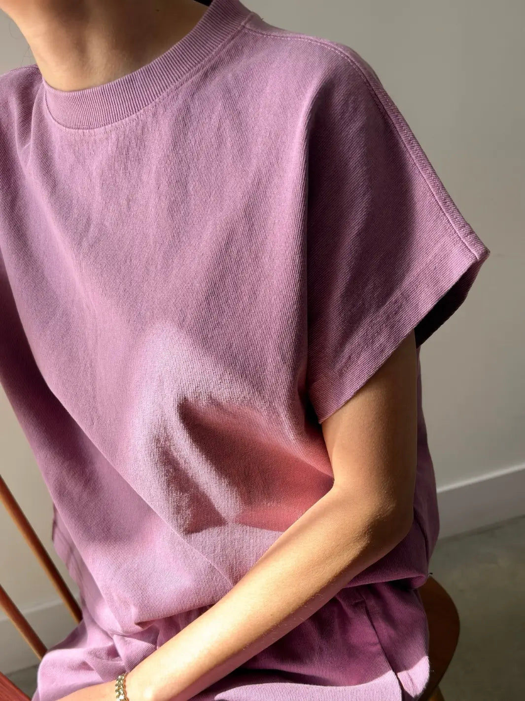 A close-up side angle shot of a model wearing the Le Bon Shoppe Jeanne Tee in Dusty Lilac highlighting the cap sleeve detail and crew neckline | Twentyseven