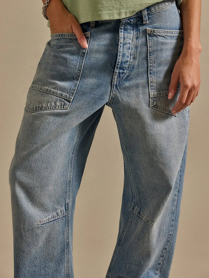 Mid-section shot highlighting the waistband, front pocket stitching, and light blue denim wash of the Free People We the Free Minimalist Moxie Barrel Jeans in County Fair | Twentyseven