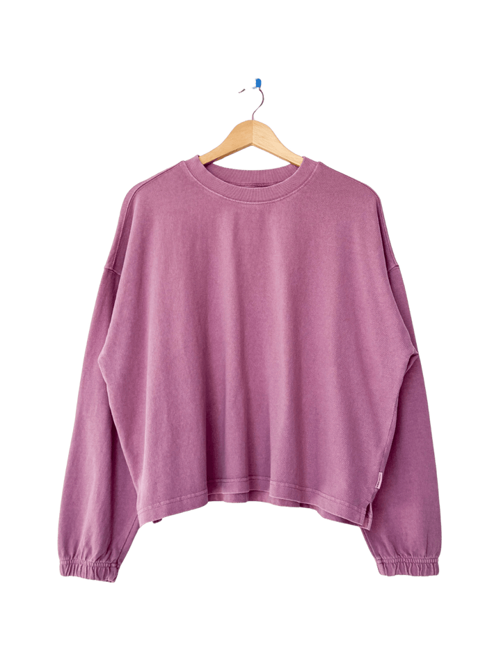 A studio product shot of the long-sleeve Le Bon Shoppe Naturelle Tee in Dusty Lilac on a wooden hanger | Twentyseven