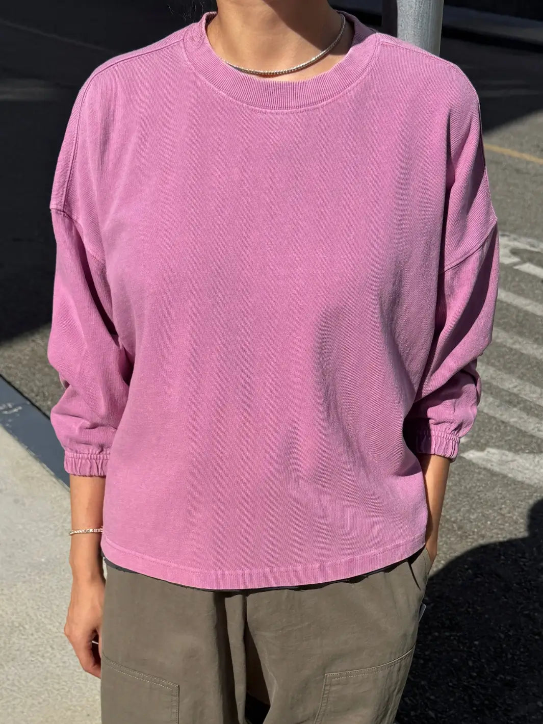A front view shot of a model wearing the long-sleeve Le Bon Shoppe Naturelle Tee in Dusty Lilac paired with olive green pants | Twentyseven