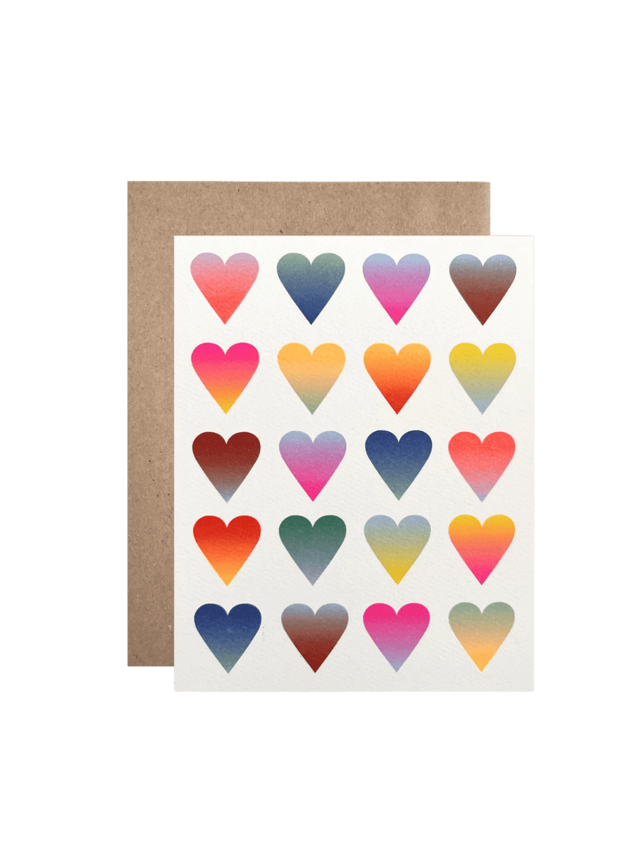 A studio product shot of the Hartland Cards Neon Gradient Hearts Card featuring rows of colorful gradient-filled hearts, displayed in front of a brown kraft envelope | Twentyseven