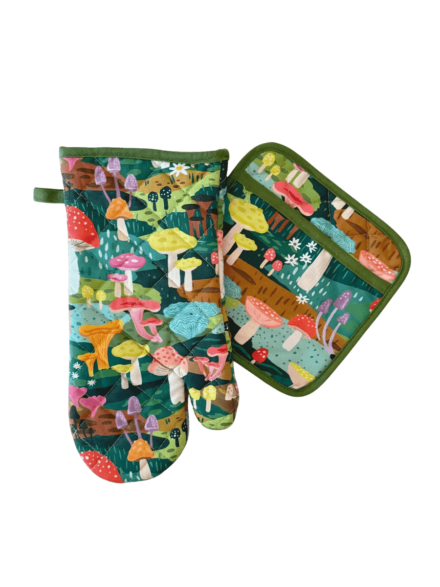 A studio product shot of the Idlewild Co. Oven Mitt + Potholder Set in Mushroom Heaven featuring a matching forest green oven mitt and potholder decorated with a colourful illustrated mushroom pattern | Twentyseven
