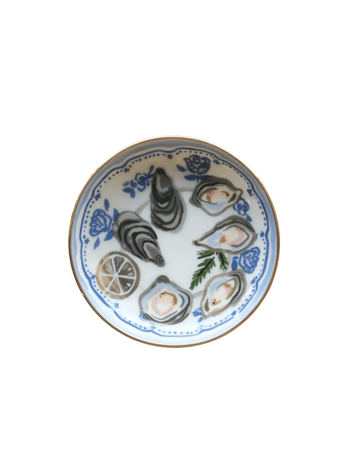 A clean studio shot of the Idlewild Co. Oysters Porcelain Trinket Dish, showing its gold-rimmed edge and blue floral-bordered oyster platter design | Twentyseven