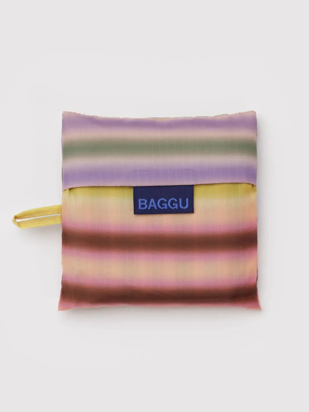 A top-down product shot showing the BAGGU Standard Baggu in Gradient Stripe Multi folded into its compact square pouch | Twentyseven