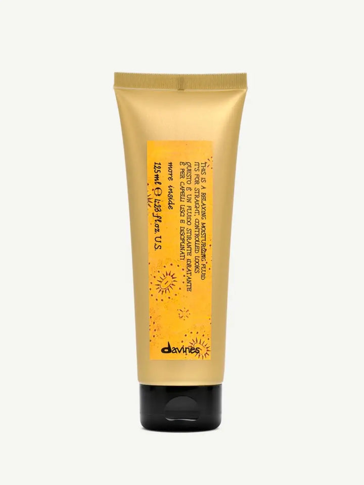Front view of the golden squeeze tube container with a black cap for Davines This is a Relaxing Moisturizing Fluid set against an off-white background | Twentyseven