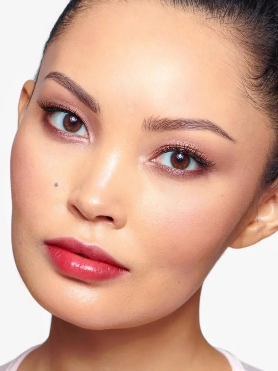 Close-up portrait of a woman wearing the vibrant pinkish-red Wonderskin WONDER BLADING Peel & Reveal Lip Color Kit - Romance | Twentyseven