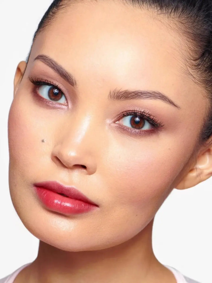 Close-up portrait of a woman wearing the vibrant pinkish-red Wonderskin WONDER BLADING Peel & Reveal Lip Color Kit - Romance | Twentyseven