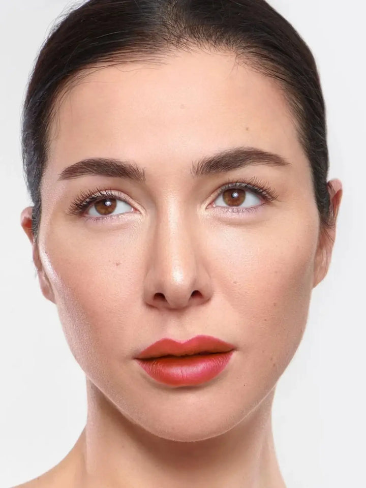 Portrait of a brunette woman looking away while showcasing the mauve-pink finish of the Wonderskin WONDER BLADING Peel & Reveal Lip Color Kit in Whimsical | Twentyseven