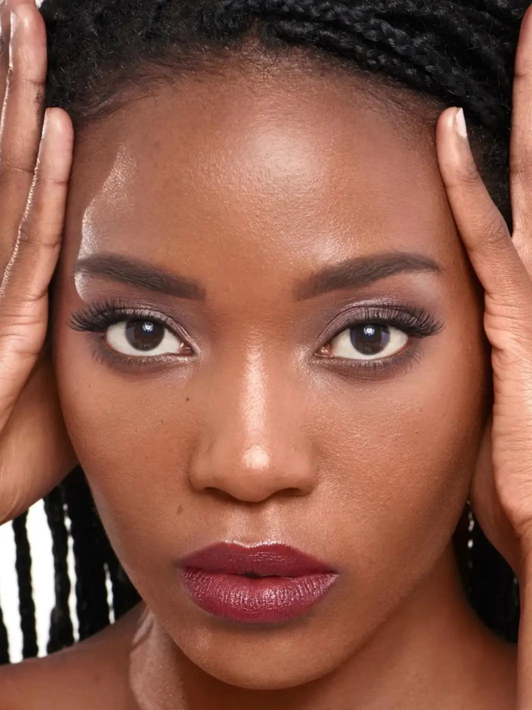 Close-up of a dark-skinned woman with braids framing her face wearing the Wonderskin WONDER BLADING Peel & Reveal Lip Color Kit in Whimsical | Twentyseven