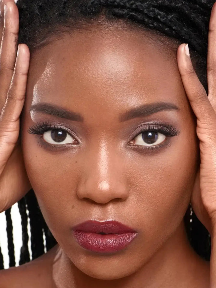 Close-up of a dark-skinned woman with braids framing her face wearing the Wonderskin WONDER BLADING Peel & Reveal Lip Color Kit in Whimsical | Twentyseven