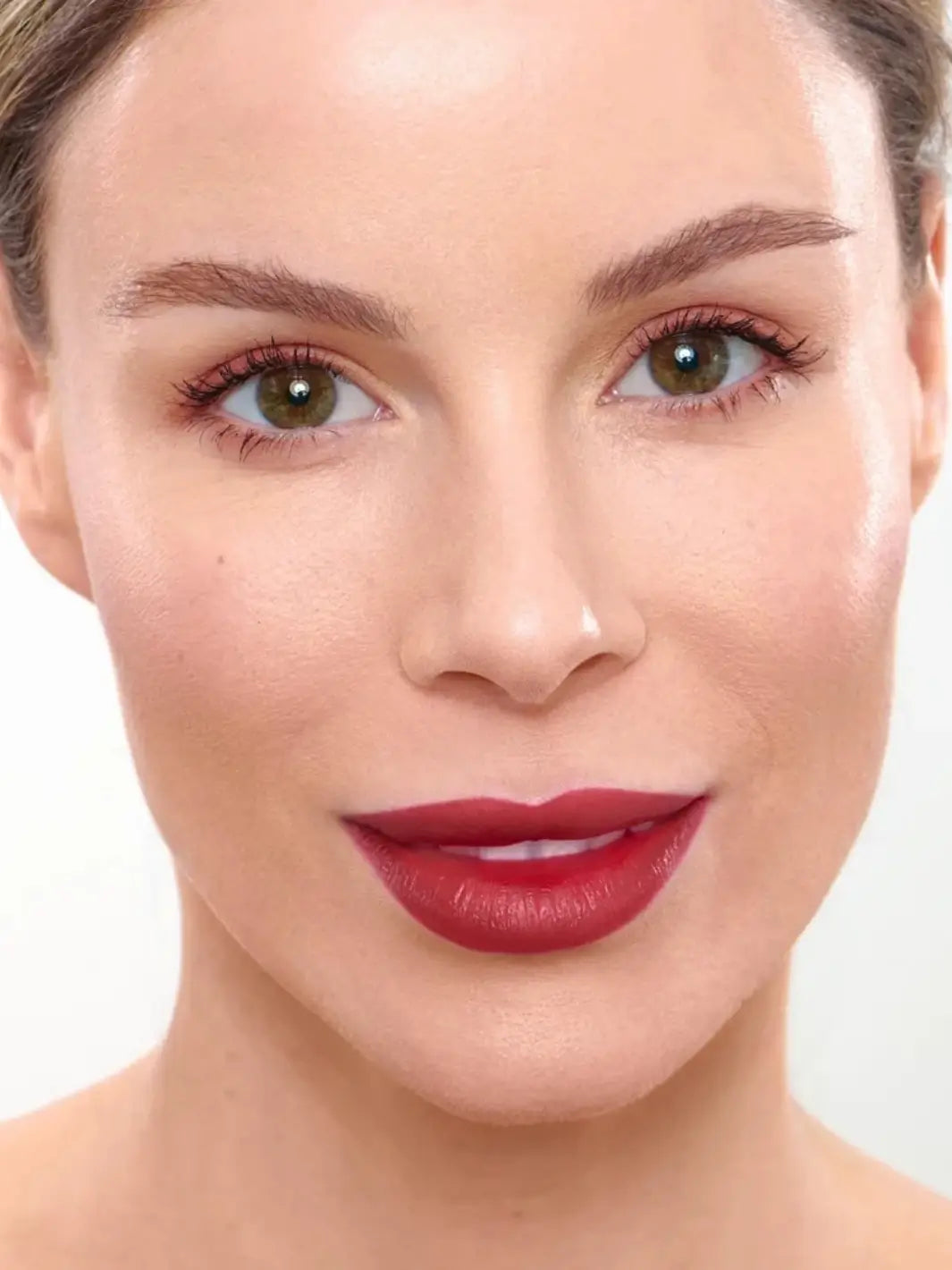 Close-up portrait of a smiling woman displaying the bold lip stain color of the Wonderskin WONDER BLADING Peel & Reveal Lip Color Kit in Whimsical | Twentyseven