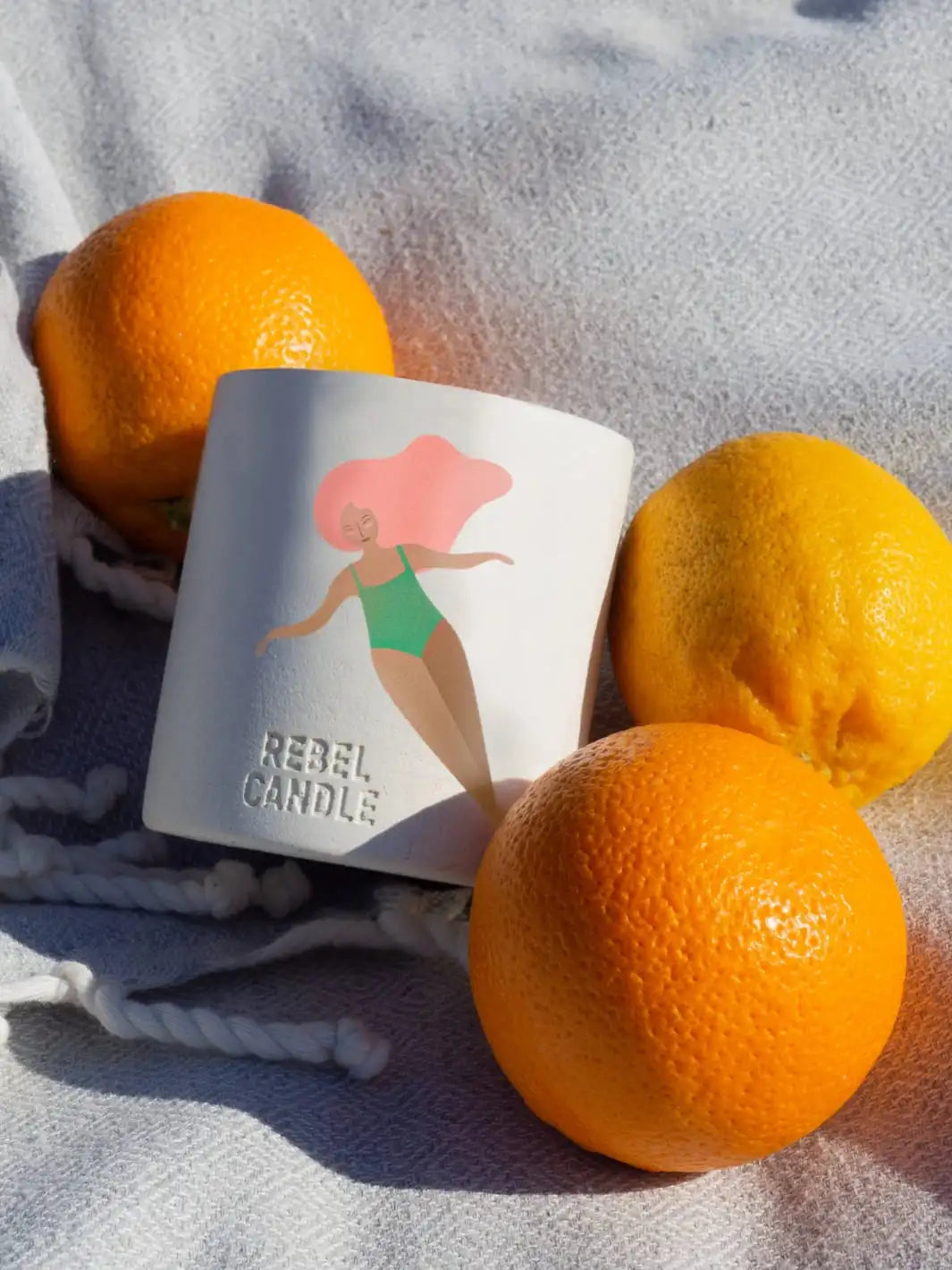 Maison Matine A Contre Courant Scented Candle with oranges on a textured surface 160g | Twentyseven Toronto