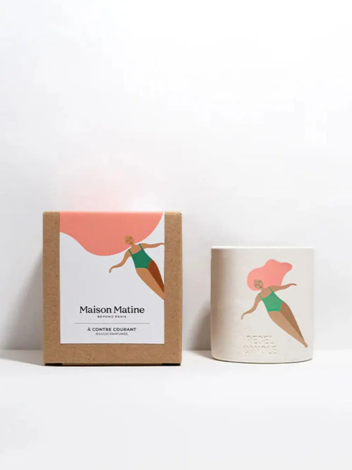 Maison Matine A Contre Courant Scented Candle and packaging with a woman in a swimsuit design on a white background 160g | Twentyseven Toronto