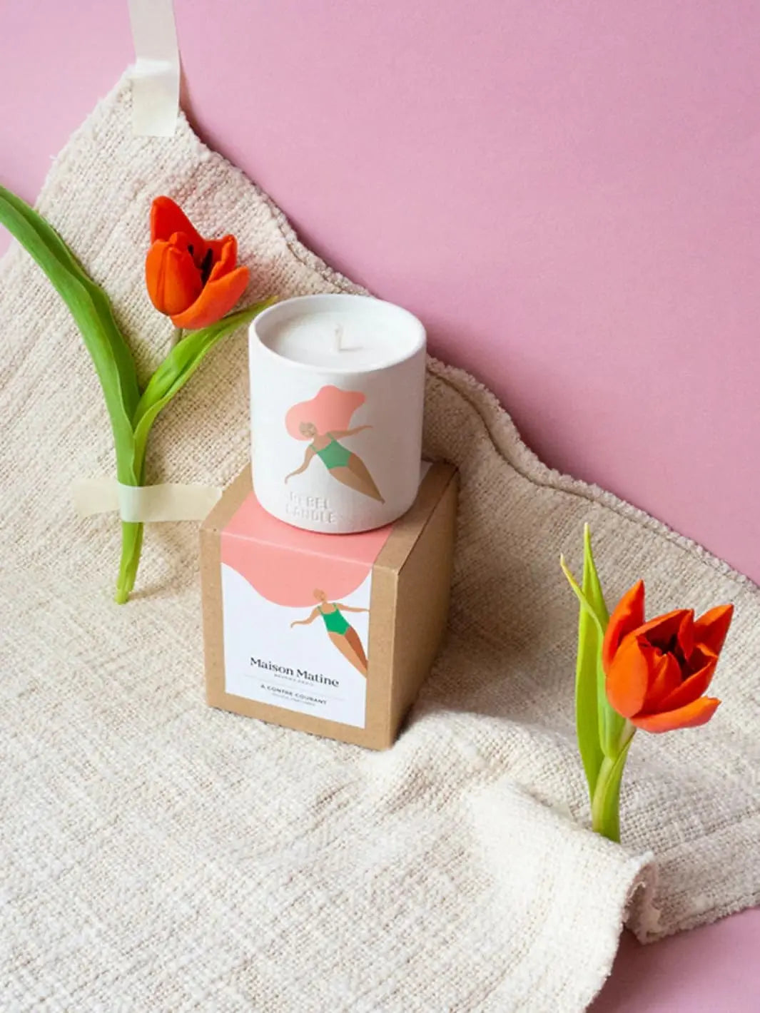 Maison Matine A Contre Courant Scented Candle with floral design on packaging box and orange tulips on a pink background 160g | Twentyseven Toronto