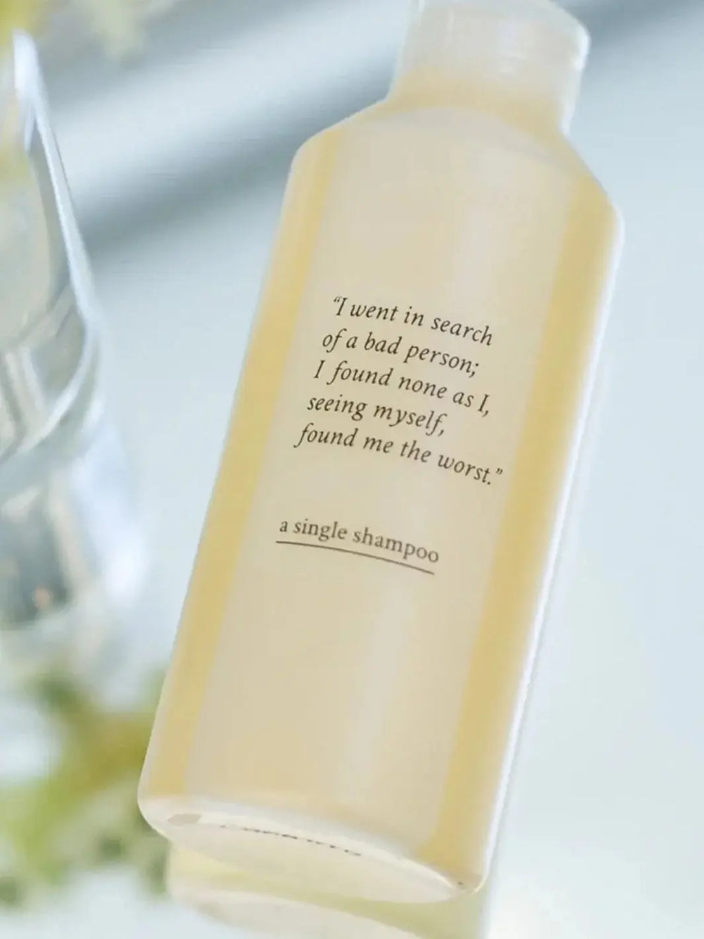 A translucent bottle of Davines A Single Shampoo is shown at a slight angle against a clean, light background | Twentyseven Toronto