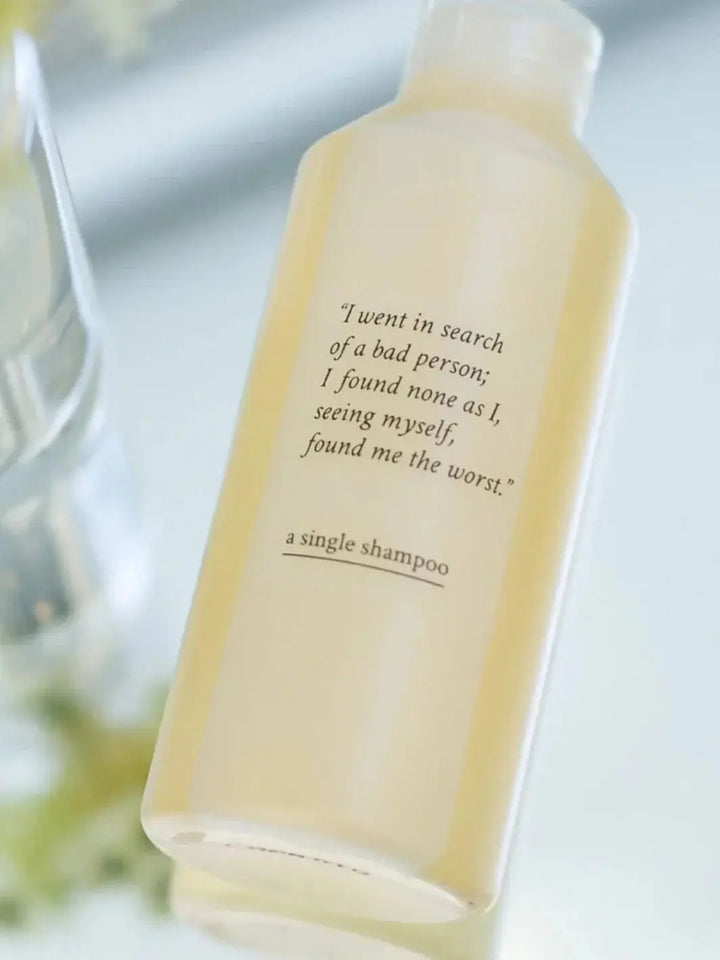 A translucent bottle of Davines A Single Shampoo is shown at a slight angle against a clean, light background | Twentyseven Toronto