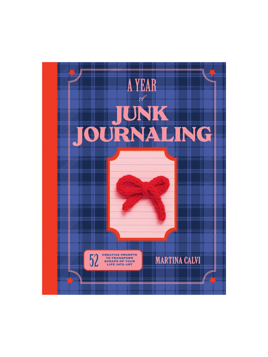 Book cover of A Year of Junk Journaling: 52 Weeks of Prompts and Inspiration for Scrapbooking by Martina Calvi in a blue plaid background with a red spine, with a small red crocheted bow in the centre | Twentyseven Toronto