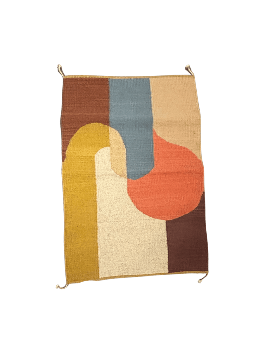 Handwoven abstract rug with curved geometric forms in ochre, cream, dusty blue, terracotta, and brown tones in a minimalist composition | Twentyseven Toronto