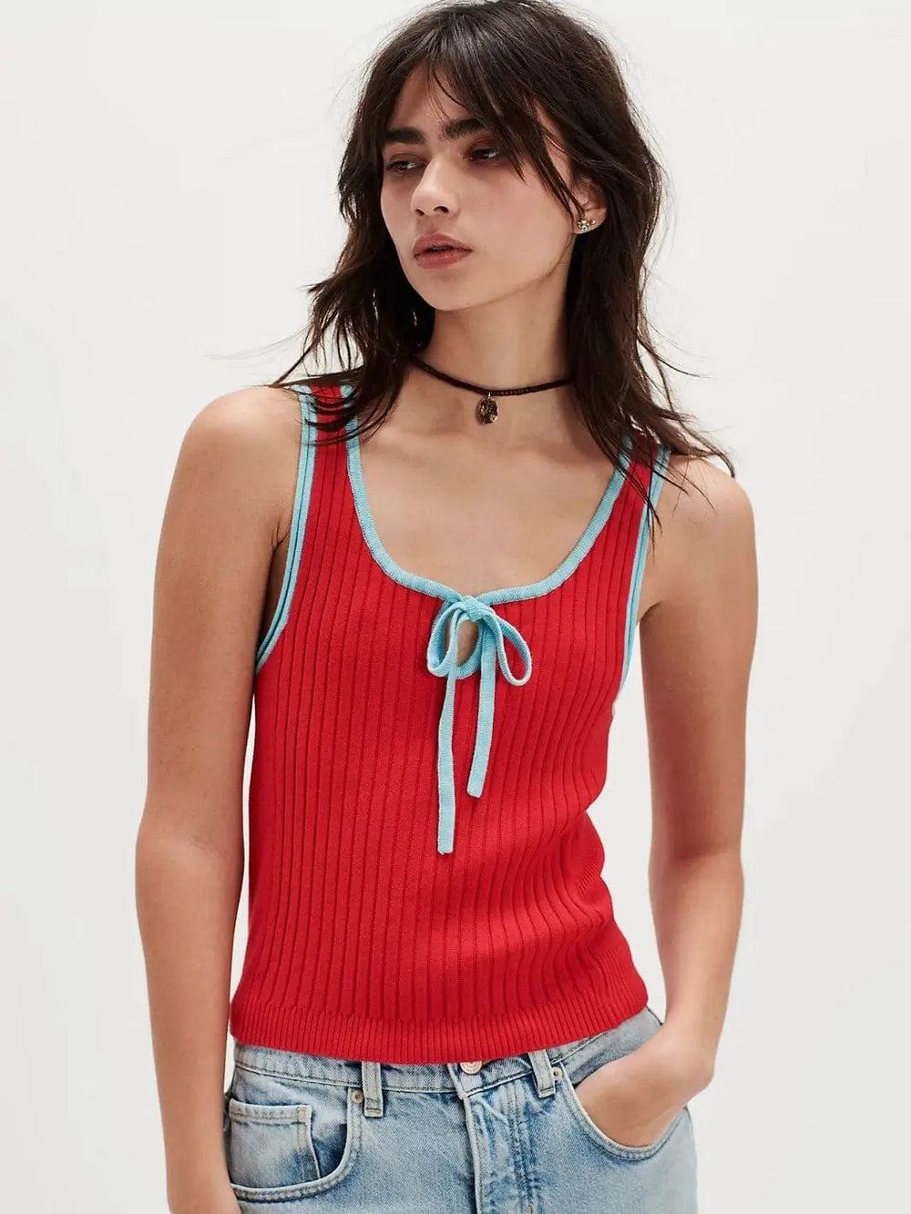 A front view shows a model with dark hair wearing the red ribbed Free People All Star Sweater Tank - Atlas Red Combo, featuring contrasting light blue trim and a front keyhole tie | Twentyseven Toronto