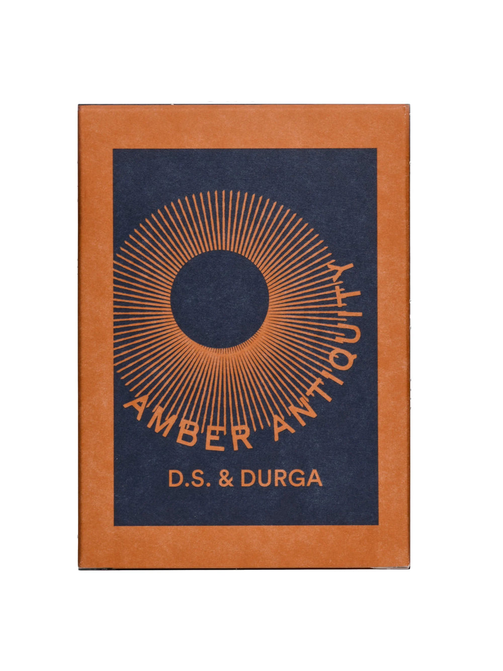 D.S. & Durga Amber Antiquity Candle packaging in amber and navy with radiating sun graphic | Twentyseven Toronto