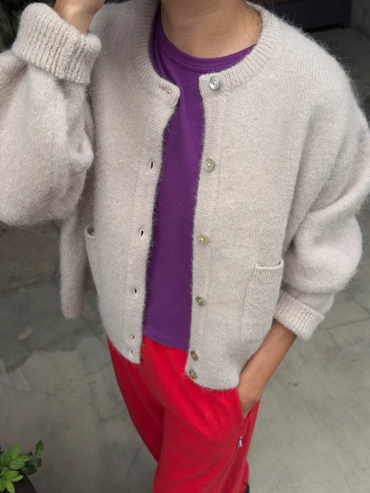 Amélie Alpaca Cardigan in Smoke styled open over a purple tee with red trousers, showing its relaxed fit and balloon sleeves | Twentyseven Toronto