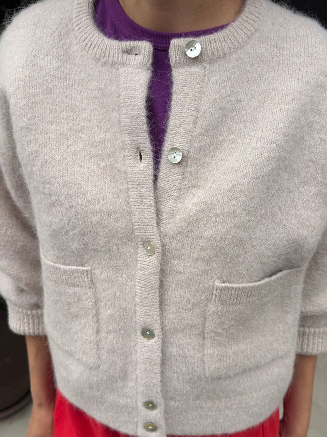 Close-up of the Amélie Alpaca Cardigan in Smoke, highlighting its shell buttons, front patch pockets and soft alpaca-wool texture | Twentyseven Toronto 