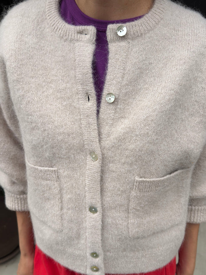 Close-up of the Amélie Alpaca Cardigan in Smoke, highlighting its shell buttons, front patch pockets and soft alpaca-wool texture | Twentyseven Toronto 