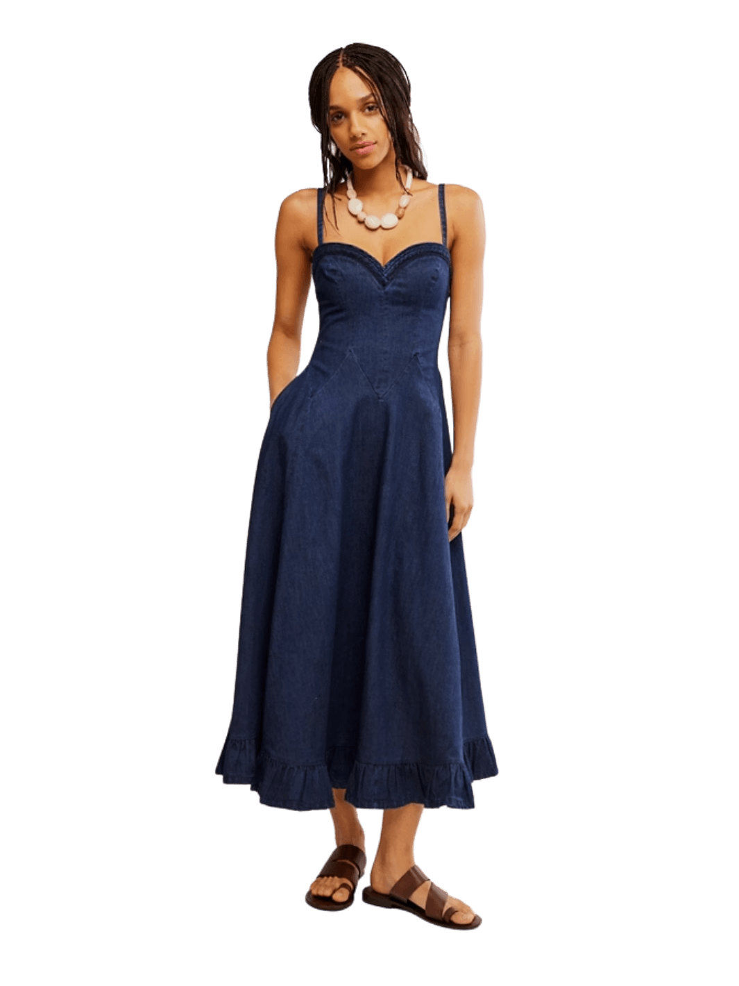A model wearing the Free People Another Season Denim Midi Dress in Rinse styled with a chunky white necklace and brown leather sandals | Twentyseven Toronto