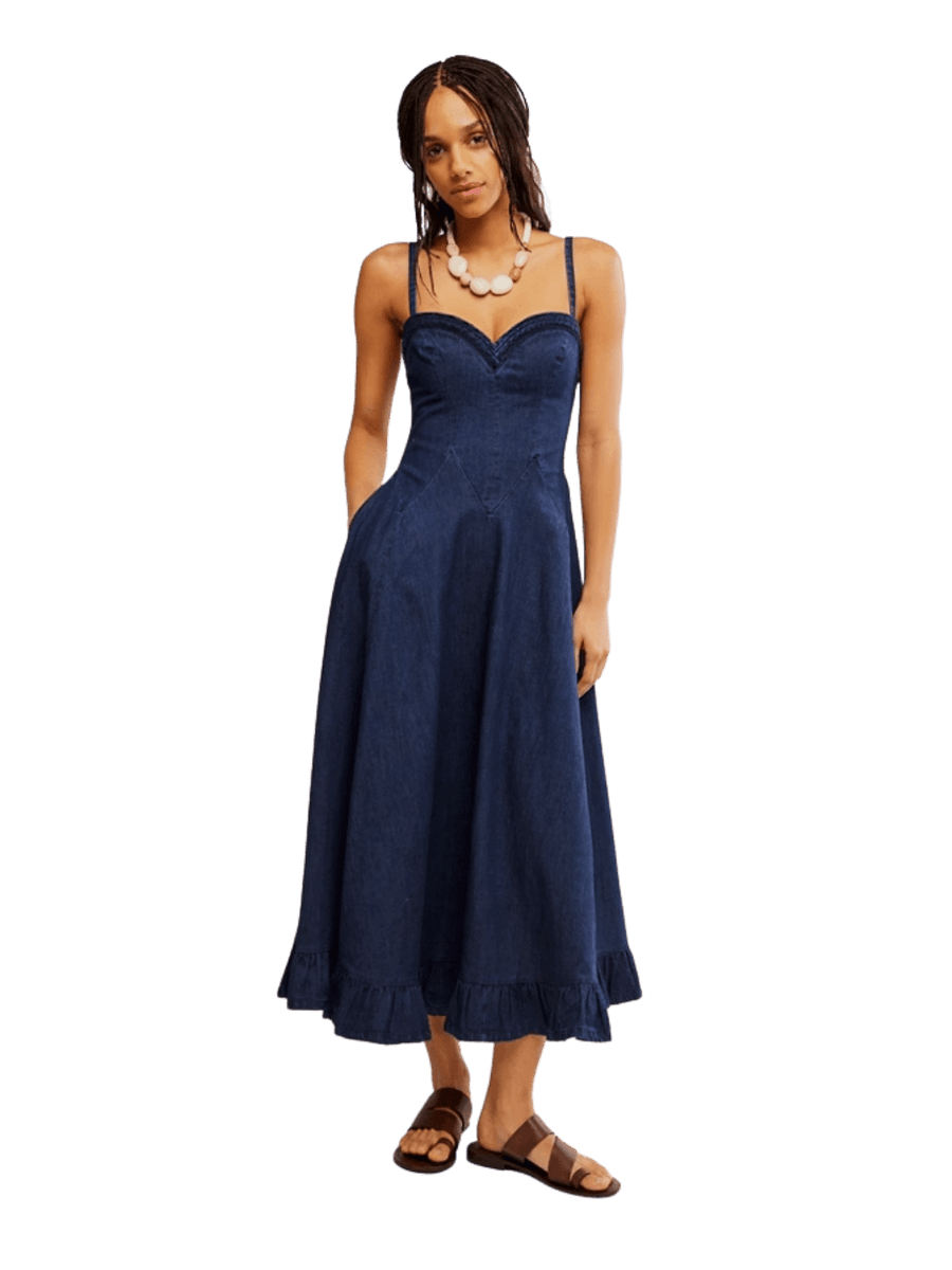 A model wearing the Free People Another Season Denim Midi Dress in Rinse styled with a chunky white necklace and brown leather sandals | Twentyseven Toronto
