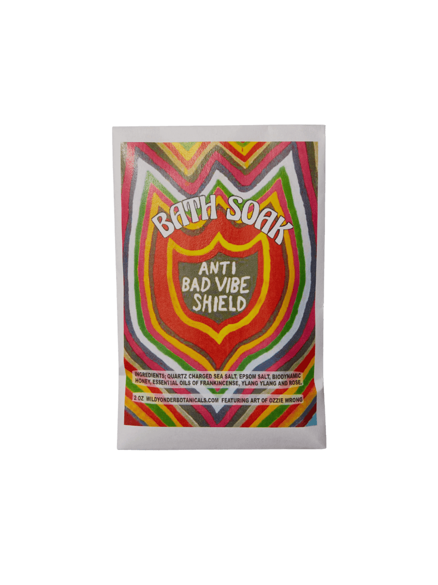 A paper pouch of Wild Yonder Studio Anti Bad Vibe Shield Bath Soak or Body Scrub features vibrant, multicolored psychedelic artwork by Ozzie Wrong on its front label | Twentyseven Toronto