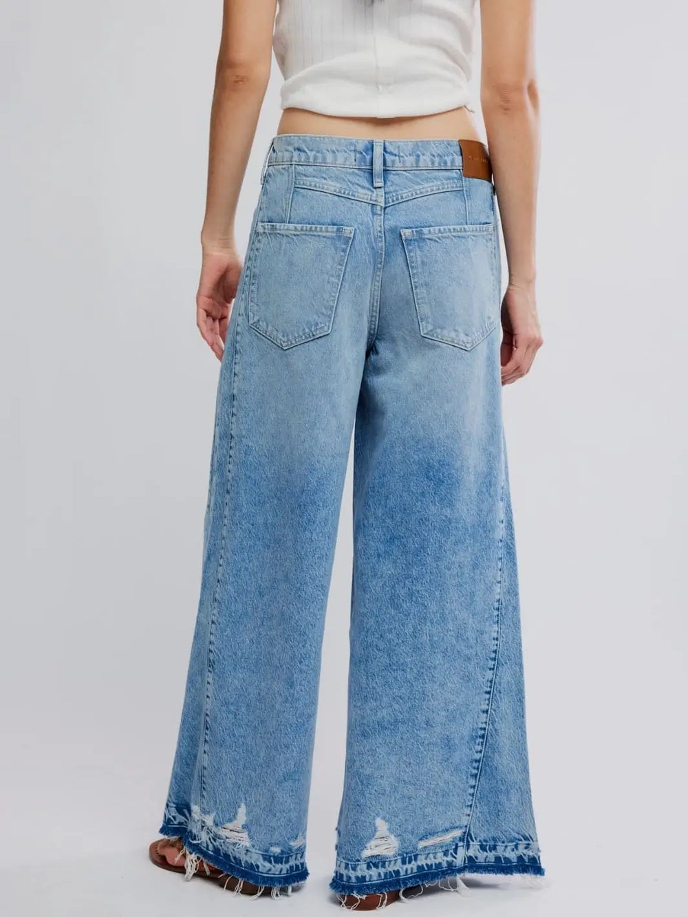 A straight-on rear view highlights the back pockets, leather brand patch, and wide hem design of the Free People Apollo Wide Leg in Streamline | Twentyseven Toronto