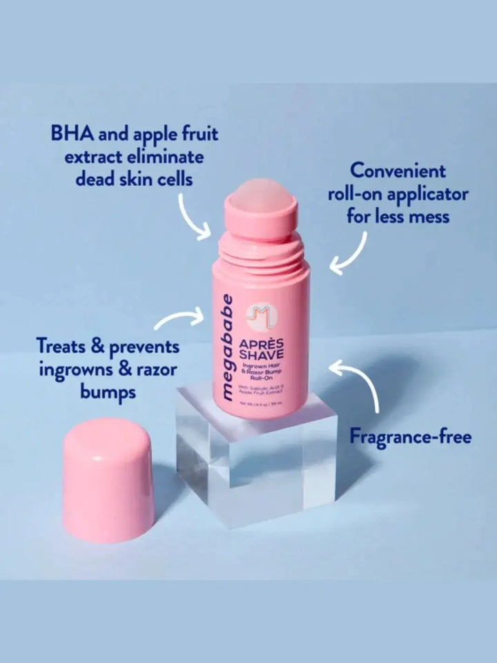An opened pink roll-on container stands on a clear acrylic cube against a light blue backdrop, surrounded by text callouts pointing out the key benefits of Megababe Après Shave | Twentysveen Toronto