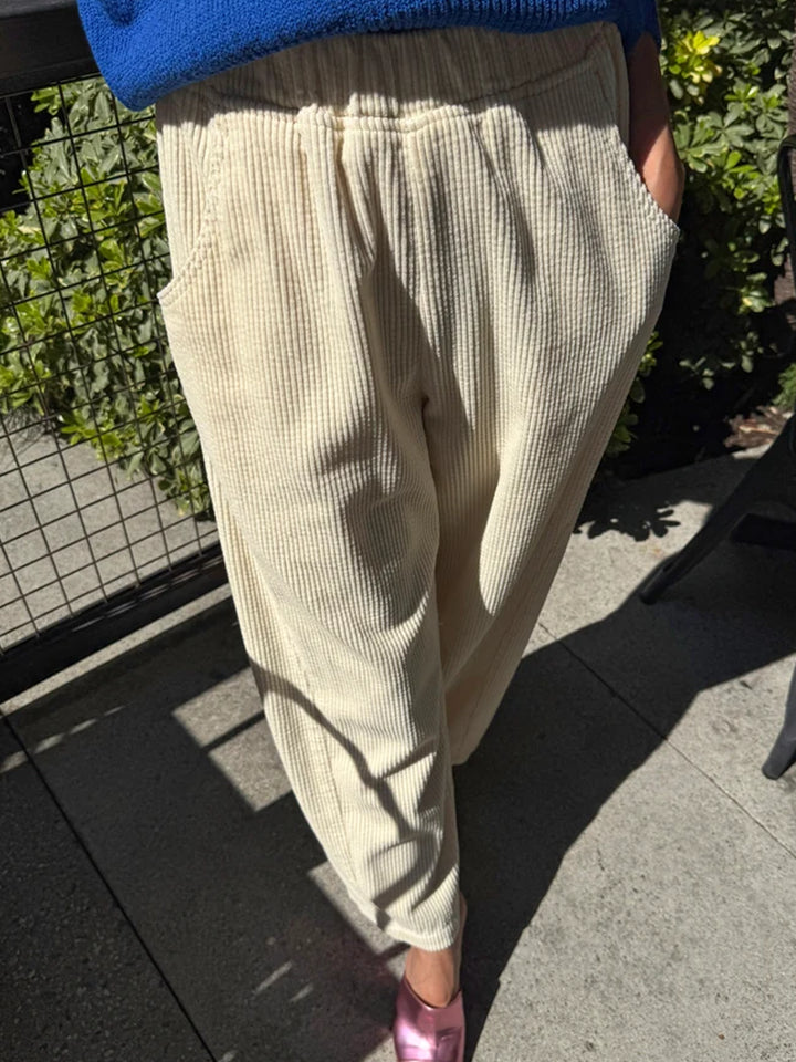Le Bon Shoppe Soft Corduroy Arc Pants in Ecru worn outdoors, front view showing elastic waist and deep pockets | Twentyseven Toronto