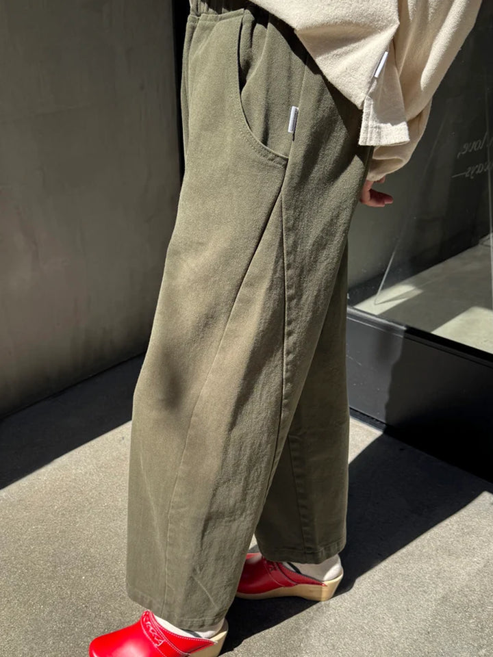 Side view of Le Bon Shoppe Arc Pants in Olive, showing the curved pocket and seam detailing | Twentyseven Toronto