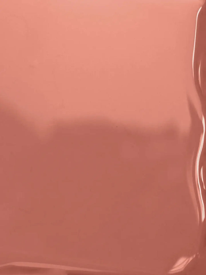 A close-up, full-frame texture shot showing the smooth, glossy, fluid surface of the BKIND Nail Polish in Arizona formula | Twentyseven Toronto