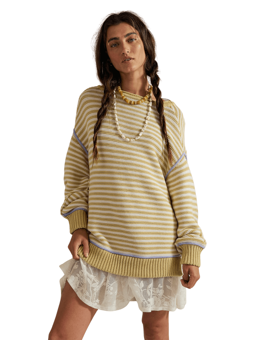 A model with braided dark hair standing in the slouchy Free People We the Free Asher Pullover in Sand Combo and a white lace mini skirt | Twentyseven Toronto