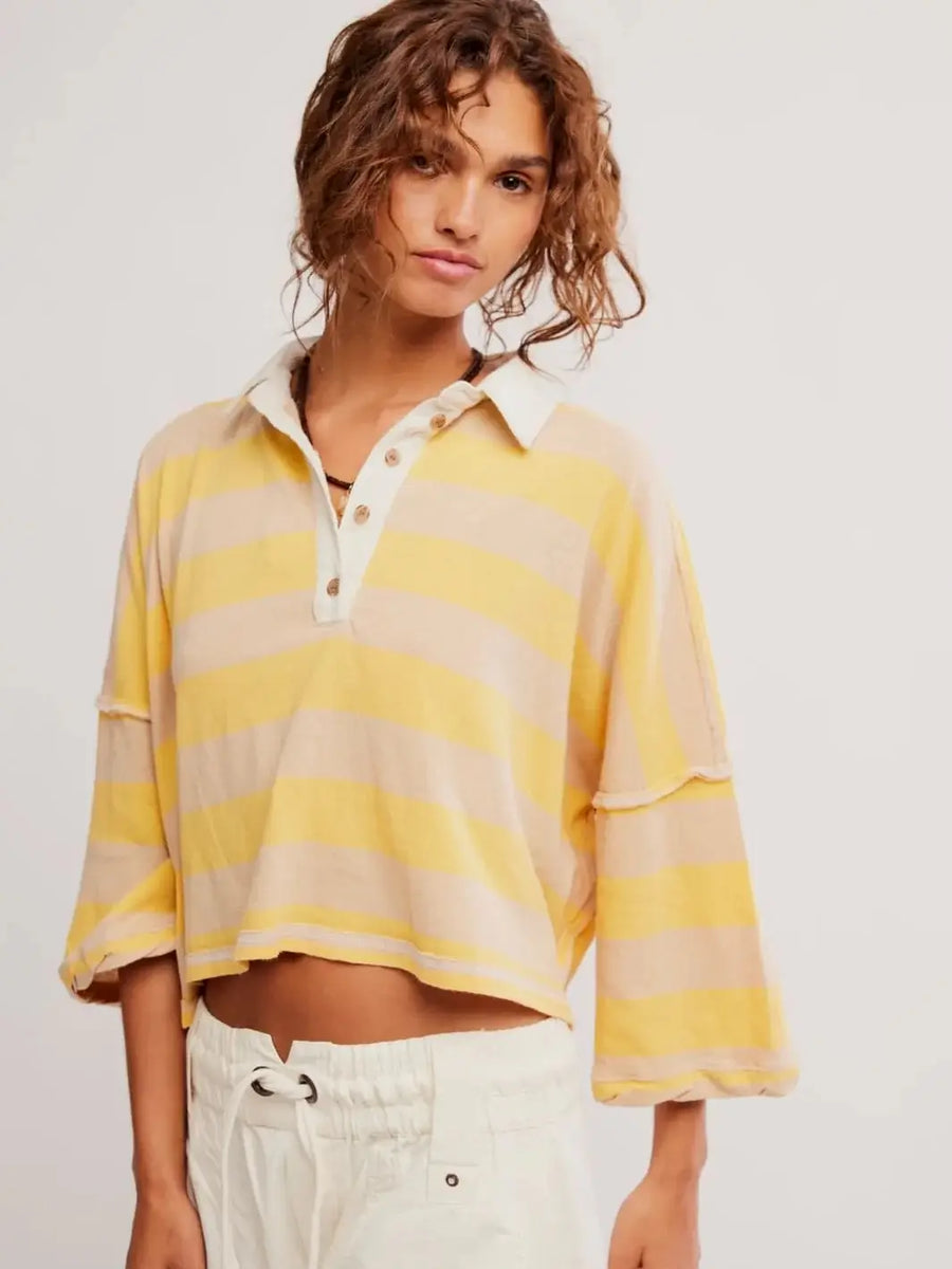 A front view showcases the cropped fit, yellow and beige horizontal stripes, and white buttoned collar of the Free People Auggie Tee in Oat Latte/Yellow Fin | Twentyseven Toronto