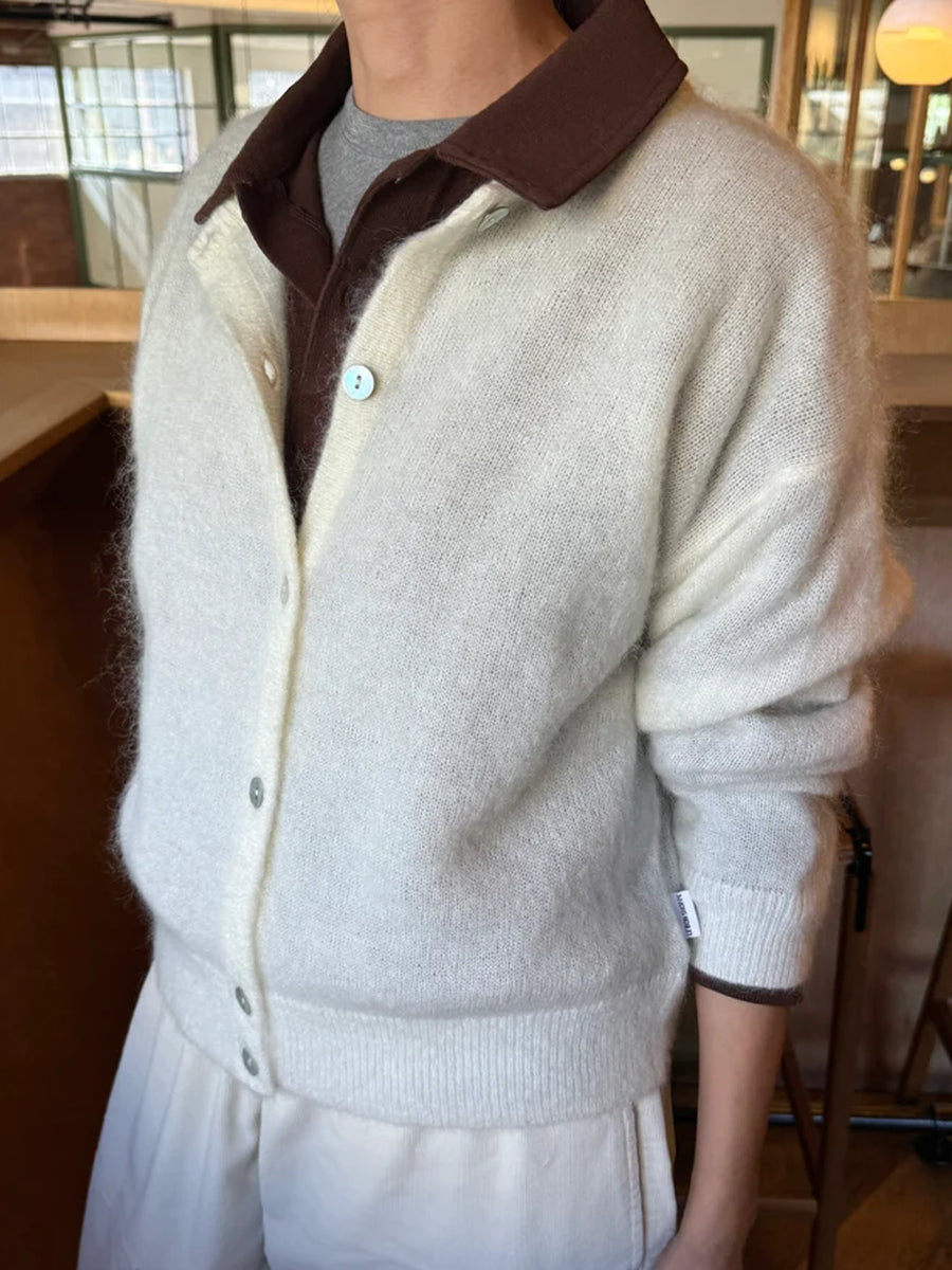 Model wearing the Le Bon Shoppe Ayla Cardigan in Pearl layered over a brown collared shirt, styled with cream trousers, showing its relaxed fit and soft knit texture | Twentyseven Toronto