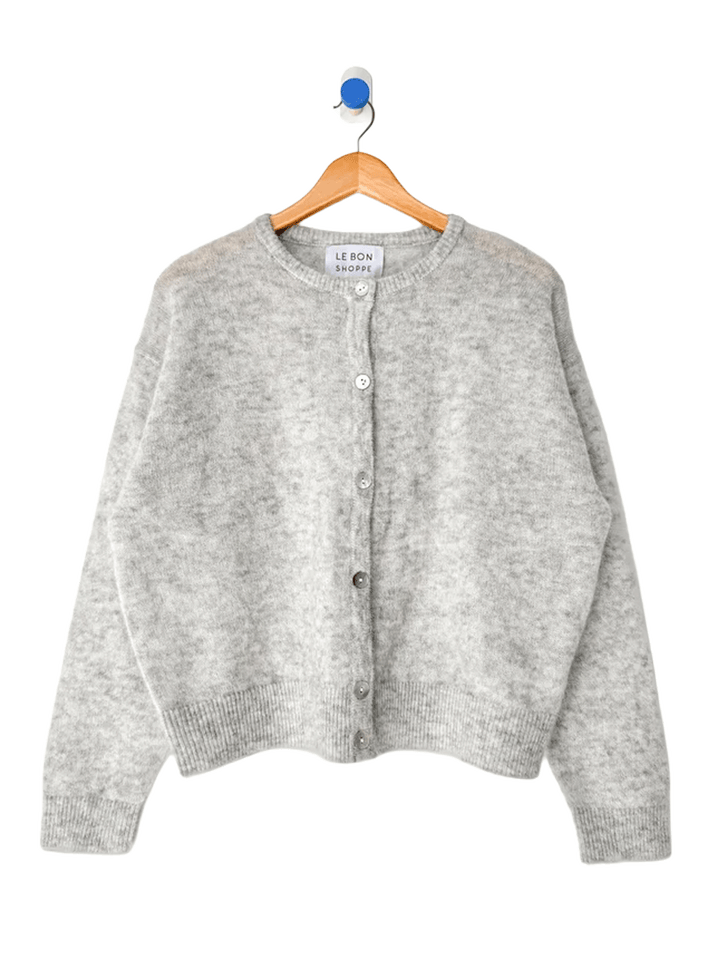 Le Bon Shoppe Ayla Mohair Cardigan in Heather Grey displayed on a wooden hanger, featuring a crew neckline and shell button front | Twentyseven Toronto