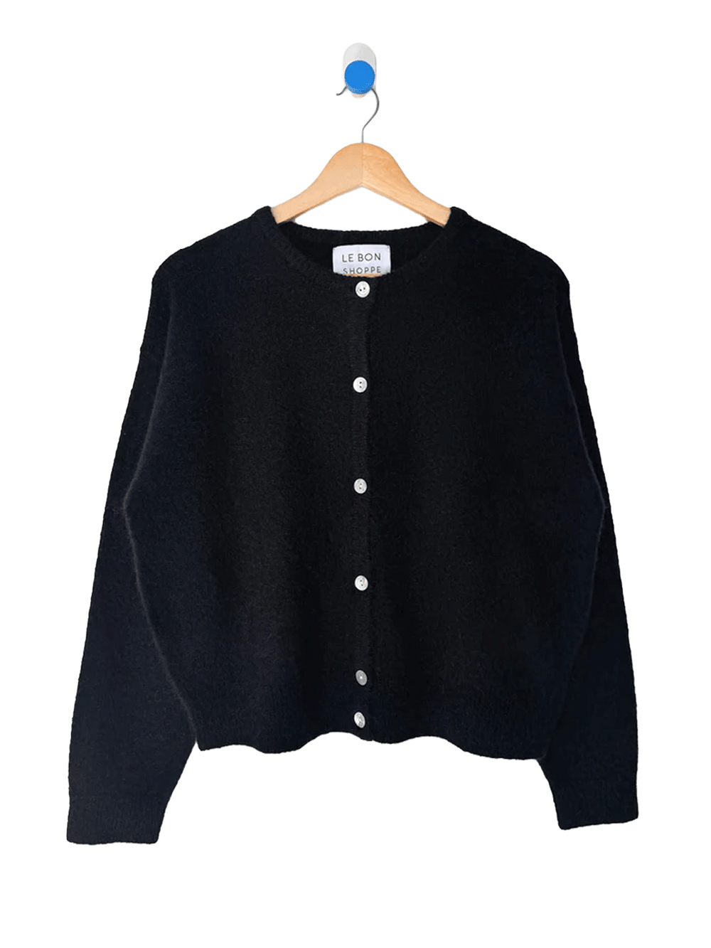 Le Bon Shoppe Ayla Mohair Cardigan in Onyx displayed on a wooden hanger, featuring a relaxed fit and shell button front | Twentyseven Toronto