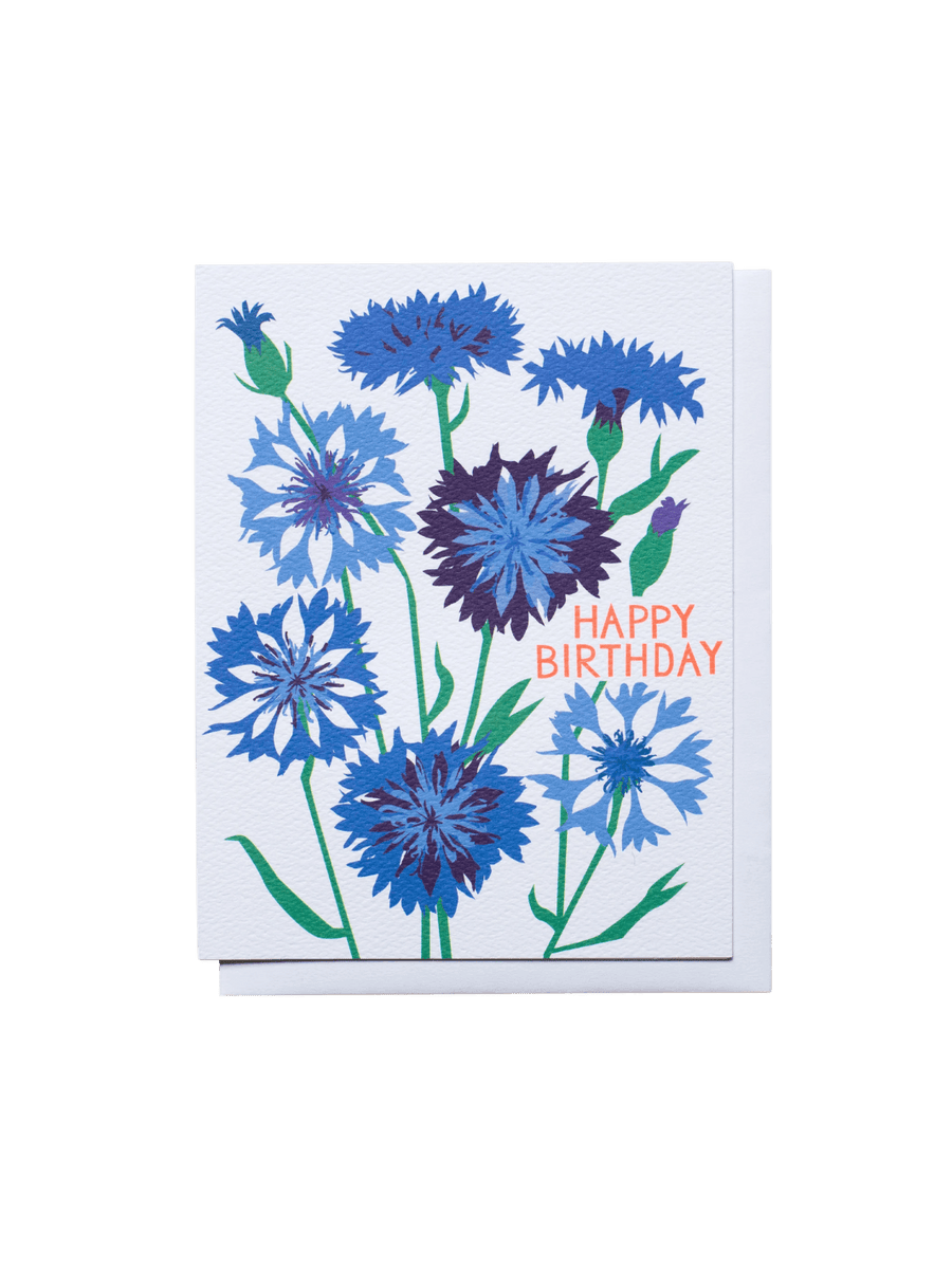The Banquet Workshop Bachelor's Buttons Birthday Note Card features a beautiful illustration of blue and purple cornflowers on a textured white card with the words "HAPPY BIRTHDAY" printed in bright orange | Twentyseven