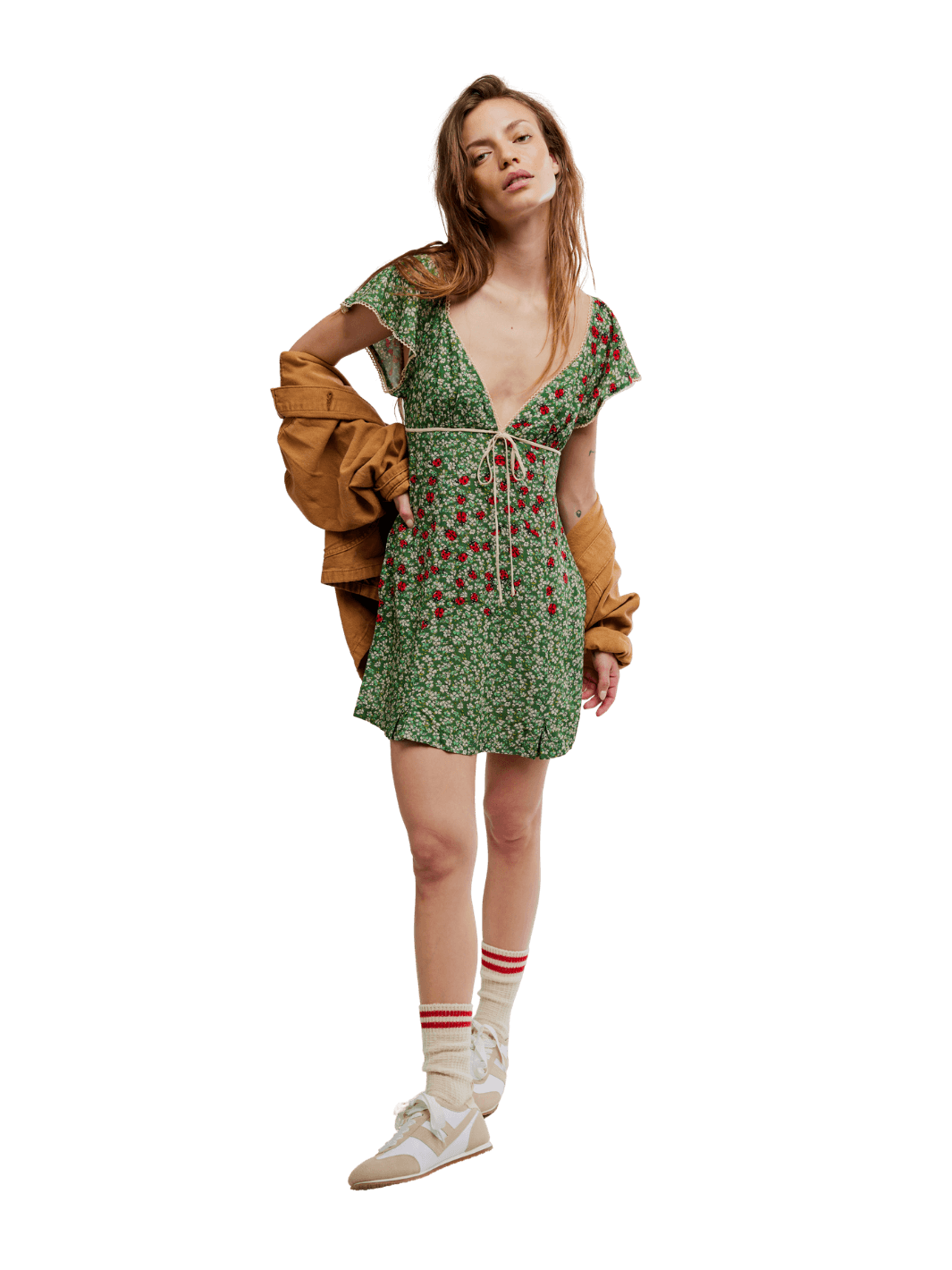 Woman wearing a green 'Backroads Mini in Forest Combo' floral dress with a brown jacket from Free People on a transparent background | Twentyseven Toronto
